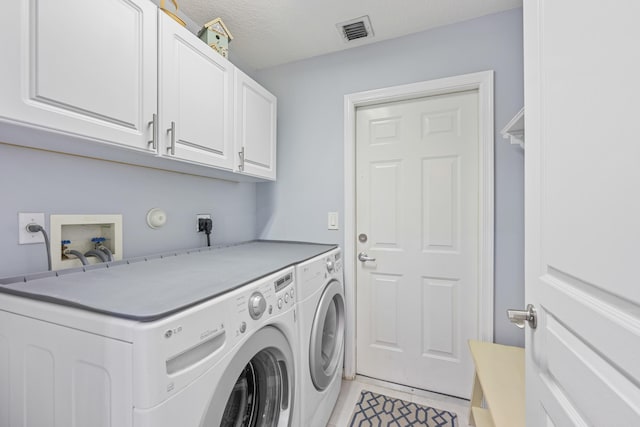 laundry area with light tile patterned flooring, cabinets, separate washer and dryer, and a textured ceiling