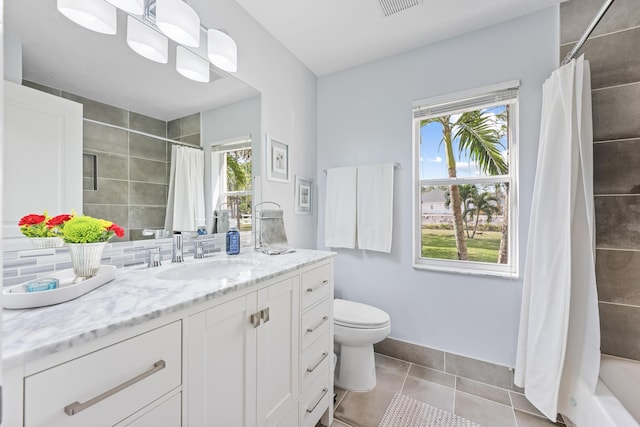 bathroom with curtained shower, toilet, and a wealth of natural light