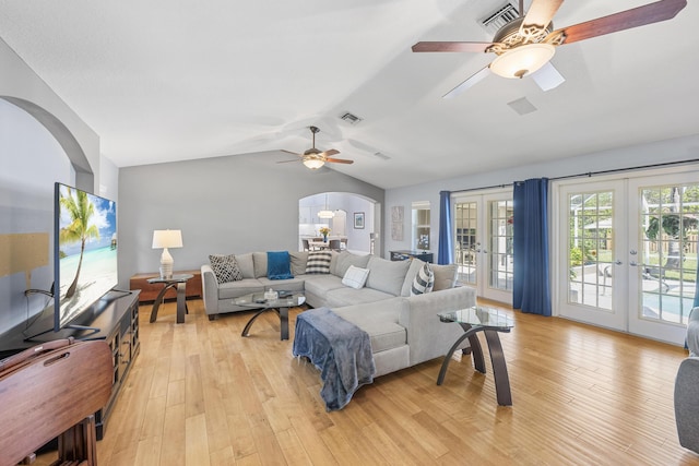 living area with french doors, arched walkways, visible vents, and light wood-style flooring