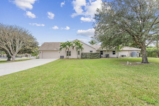 ranch-style home featuring cooling unit, a garage, and a front lawn