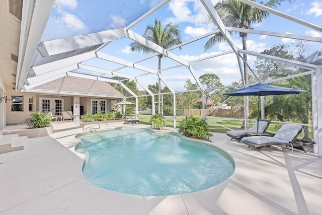 view of pool featuring a fenced in pool, fence, a lanai, french doors, and a patio area