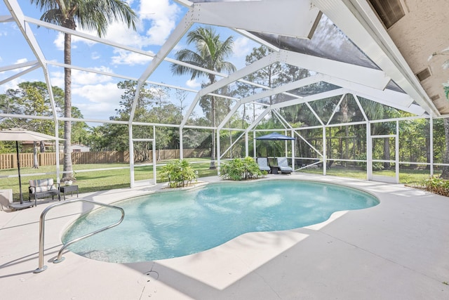 view of pool with glass enclosure, a fenced in pool, a patio area, and fence