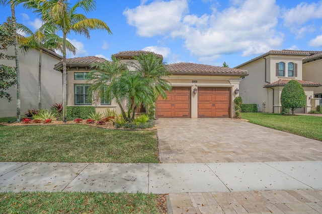 mediterranean / spanish-style home featuring a garage and a front yard