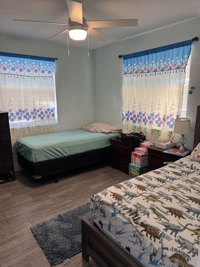 bedroom featuring wood-type flooring and ceiling fan