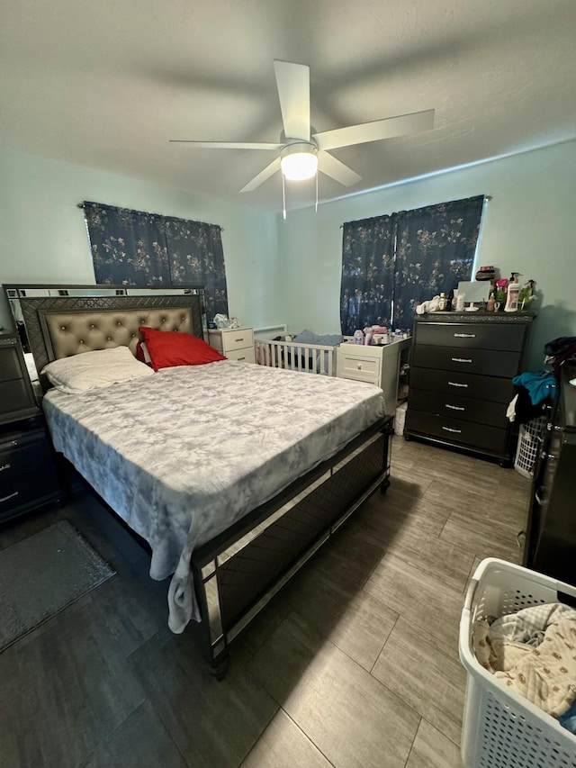 bedroom with ceiling fan and hardwood / wood-style floors