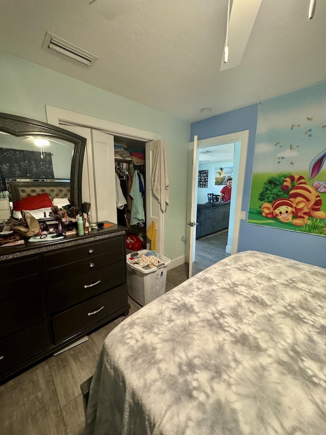 bedroom featuring dark hardwood / wood-style flooring and a closet