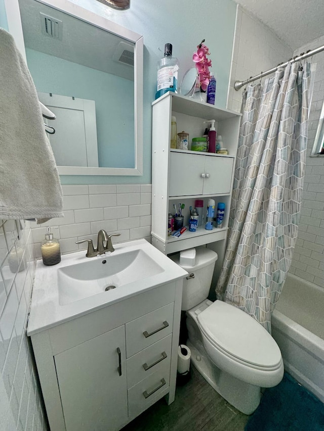 full bathroom featuring tasteful backsplash, wood-type flooring, shower / bath combination with curtain, vanity, and toilet