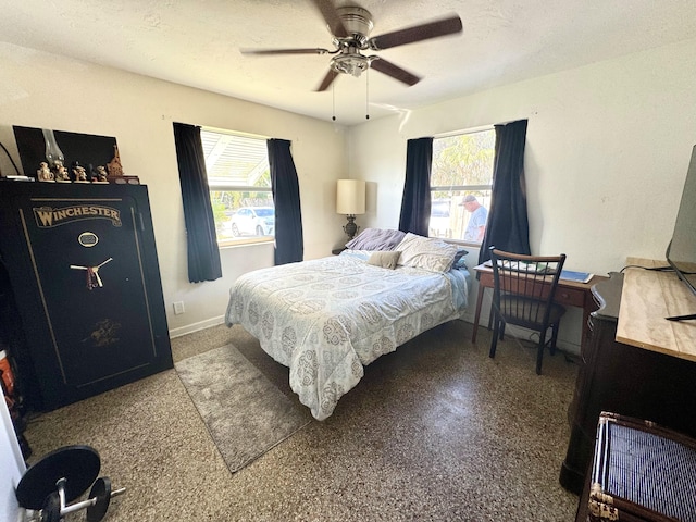 bedroom featuring ceiling fan, multiple windows, and a textured ceiling