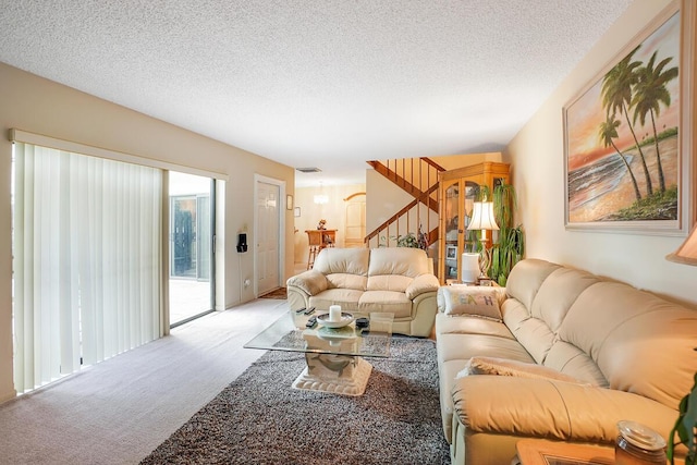 living room featuring light carpet and a textured ceiling