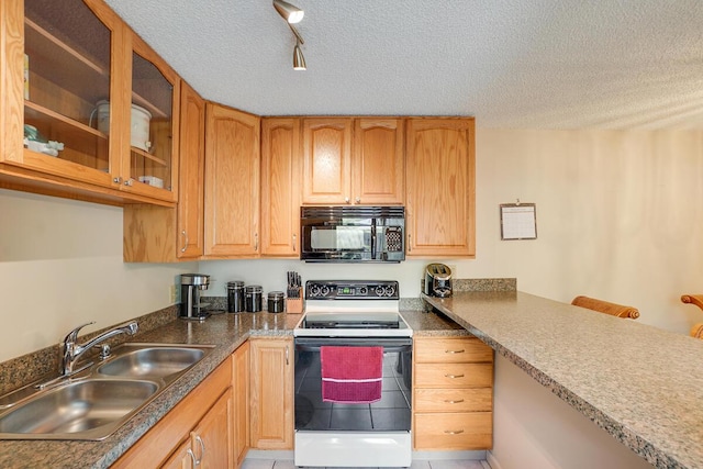 kitchen featuring electric range oven, rail lighting, sink, and a textured ceiling