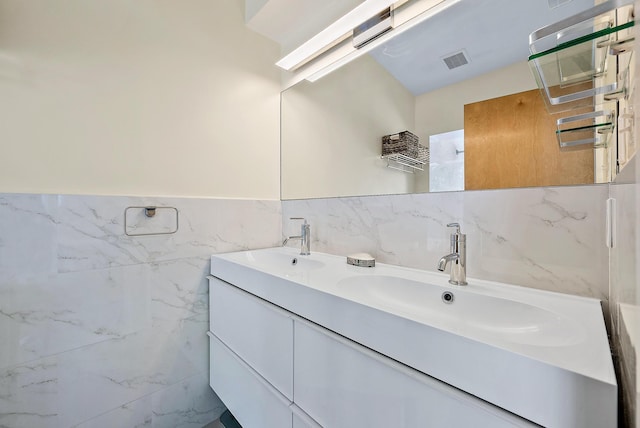 330 Franklin Rd, West Palm Beach, FL 33405 - full bathroom with tile walls, double vanity, and wainscoting