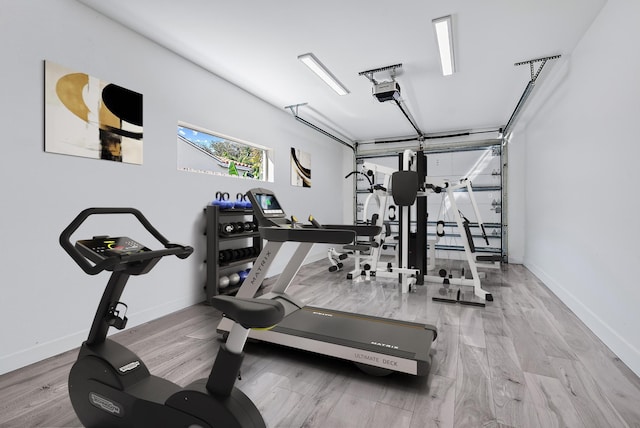 330 Franklin Rd, West Palm Beach, FL 33405 - workout area with a garage, wood finished floors, and baseboards