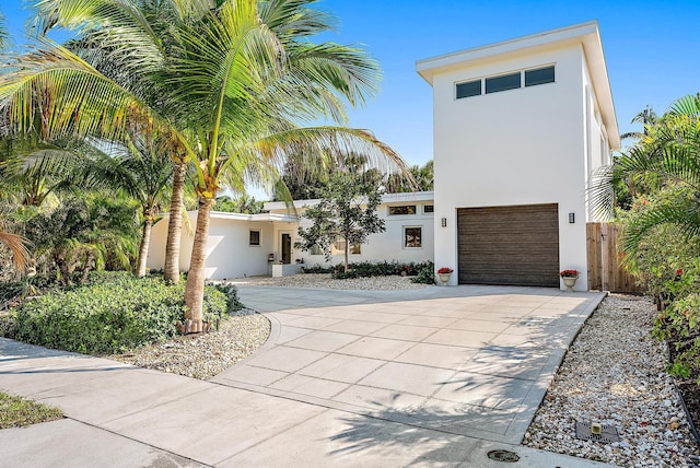330 Franklin Rd, West Palm Beach, FL 33405 - contemporary home featuring stucco siding, curved driveway, and an attached garage