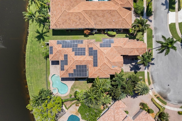 birds eye view of property with a water view