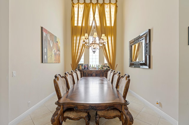 tiled dining room with a high ceiling and a notable chandelier