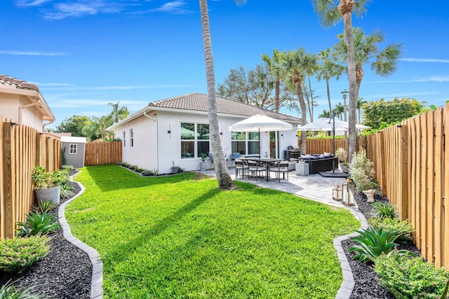 rear view of property with a hot tub, a patio, and a lawn