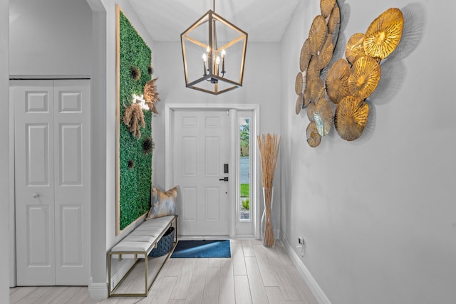 entryway with an inviting chandelier and light hardwood / wood-style floors