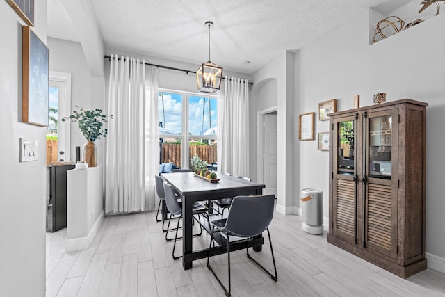 dining room featuring a notable chandelier and a textured ceiling