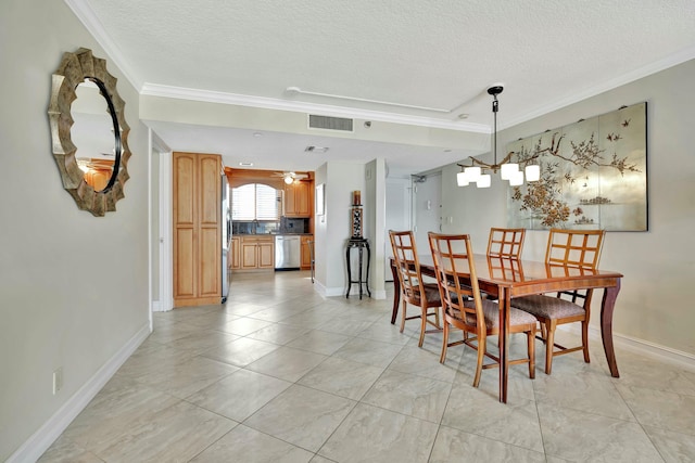 dining room with light tile patterned floors, ornamental molding, and a textured ceiling