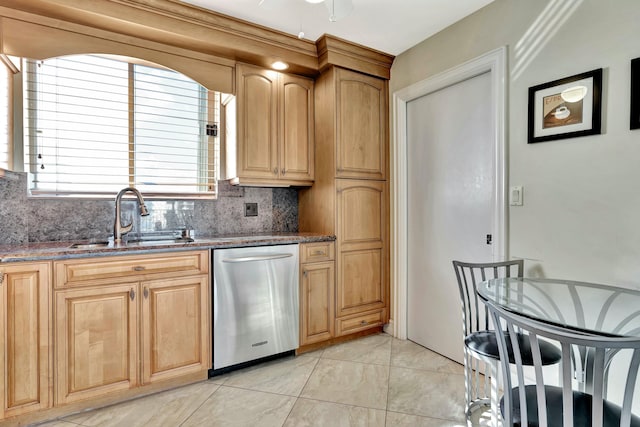 kitchen featuring dishwasher, sink, decorative backsplash, dark stone counters, and ceiling fan