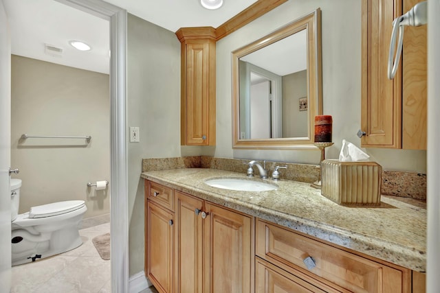 bathroom featuring vanity and toilet