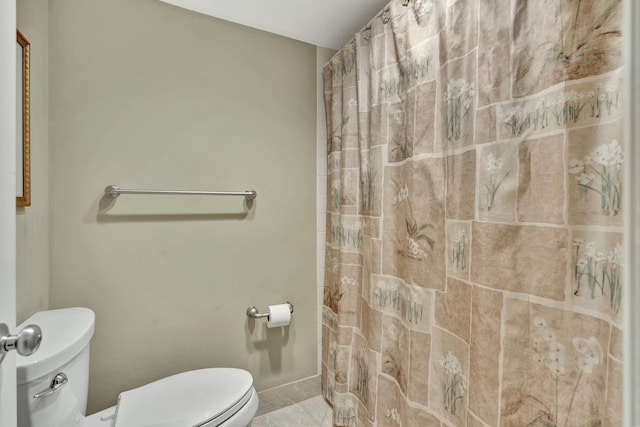 bathroom with toilet and curtained shower