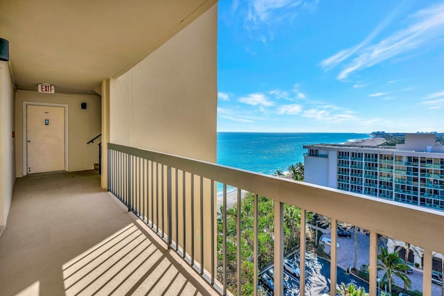 balcony with a water view and a beach view