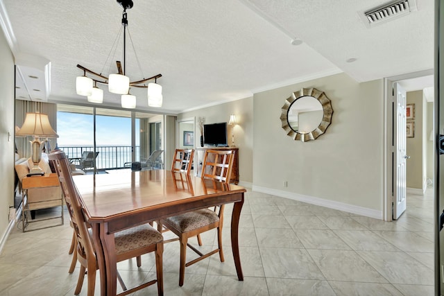 dining space with ornamental molding, expansive windows, and a textured ceiling