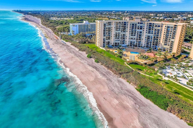 aerial view with a water view and a beach view