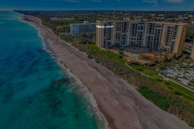 drone / aerial view with a beach view and a water view