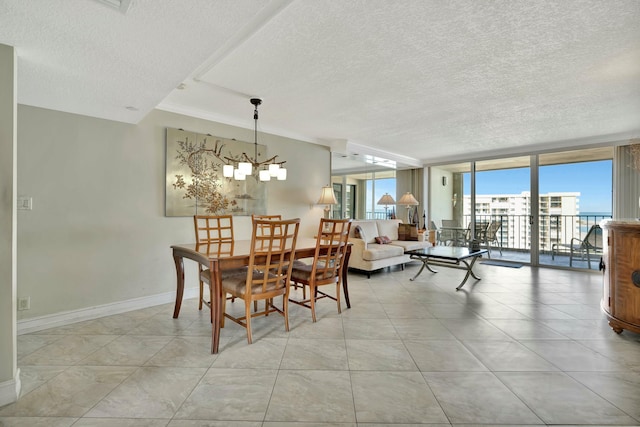 tiled dining room with an inviting chandelier, floor to ceiling windows, and a textured ceiling