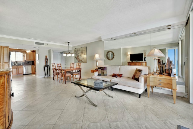 tiled living room with ornamental molding, sink, ceiling fan, and a textured ceiling