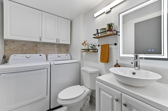 bathroom featuring vanity, toilet, and washing machine and dryer