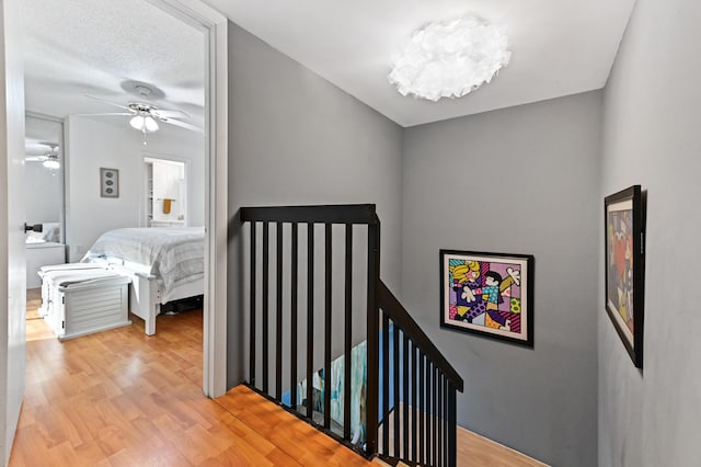 staircase featuring hardwood / wood-style flooring and ceiling fan