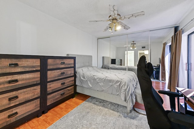 bedroom featuring ceiling fan, a closet, and light wood-type flooring