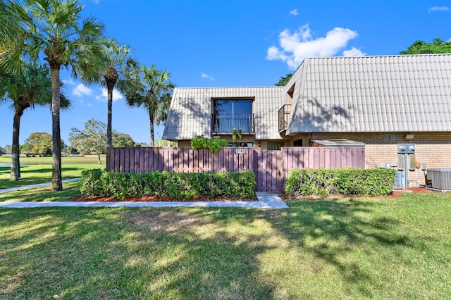 view of property exterior with a yard and cooling unit