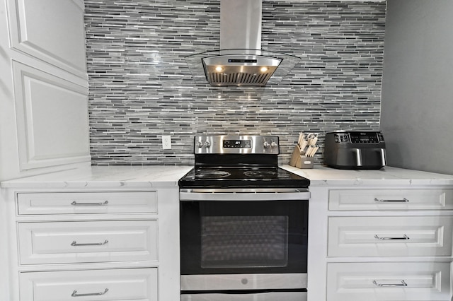 kitchen featuring white cabinetry, range hood, backsplash, and stainless steel range with electric stovetop