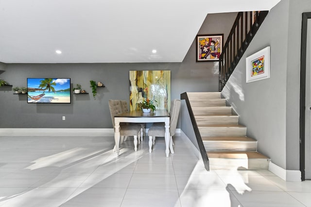 stairway featuring tile patterned flooring