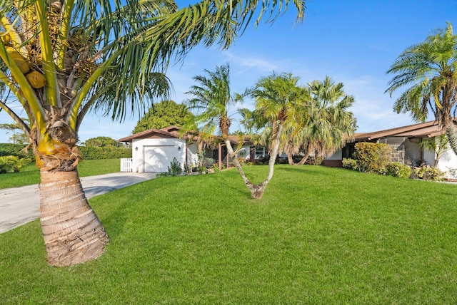 view of front of house featuring a garage and a front lawn