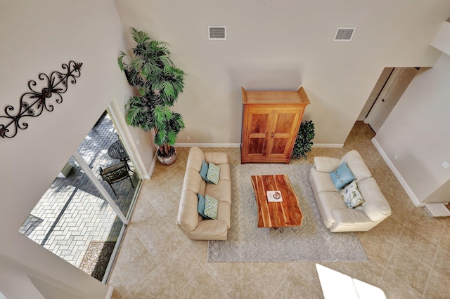 tiled living room featuring visible vents and baseboards