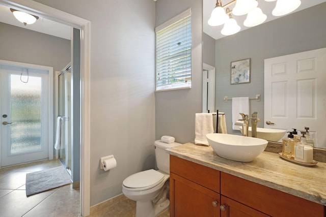 bathroom featuring toilet, a stall shower, tile patterned flooring, and vanity