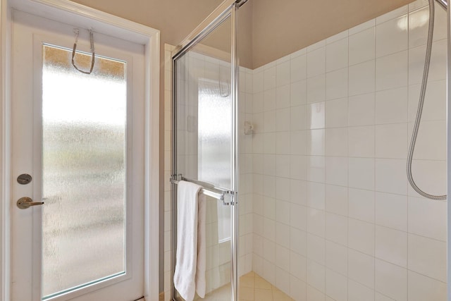 bathroom with a shower with door