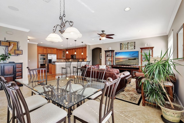 tiled dining room with crown molding and ceiling fan