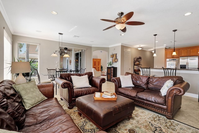 living area with light tile patterned floors, visible vents, arched walkways, ornamental molding, and recessed lighting