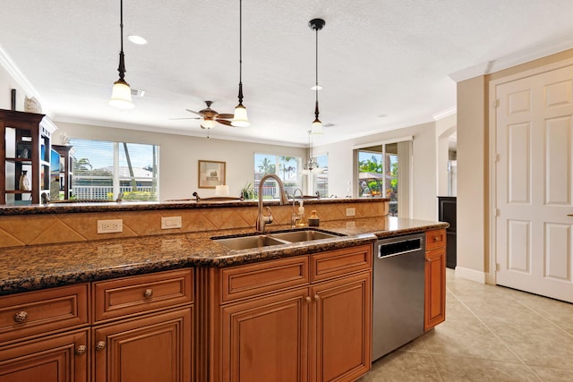 kitchen with a healthy amount of sunlight, brown cabinets, dishwasher, and a sink