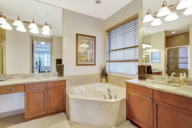 bathroom with vanity, tile patterned flooring, and plus walk in shower