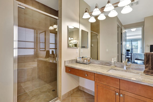 bathroom with walk in shower, vanity, and tile patterned flooring