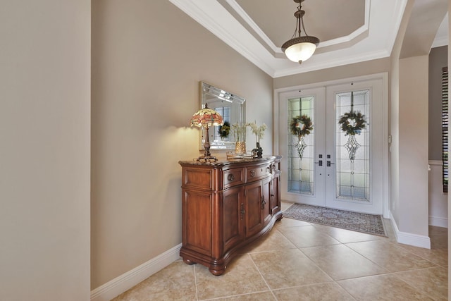 foyer entrance featuring light tile patterned floors, french doors, a raised ceiling, and crown molding