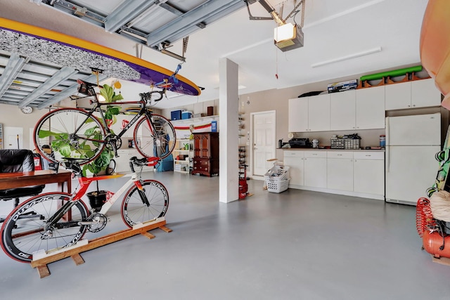 garage with a garage door opener and freestanding refrigerator