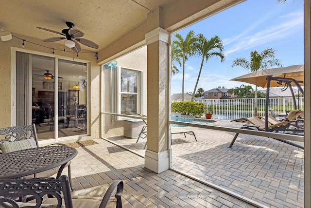 view of patio / terrace featuring a ceiling fan, a fenced in pool, and fence